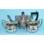 A bachelor's silver three-piece tea service of shaped rectangular form, with gadrooned edge,