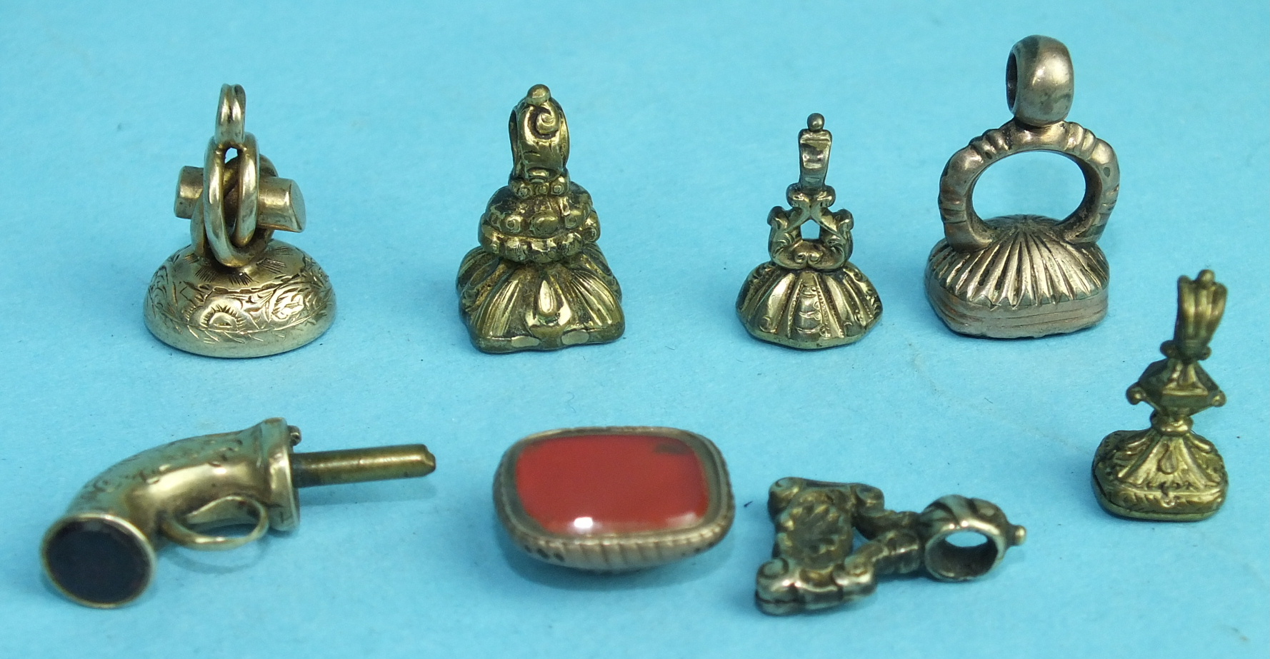 Five various miniature fob seals and one other in the form of a pistol, (barrel missing), (6).