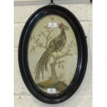 A 19th century oval embroidered silk picture of a pheasant perched in a tree, 38 x 23cm, (old