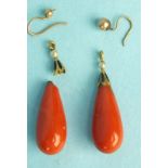 A pair of coral drops with enamelled caps, (one detached and damaged), intact drop 34mm.