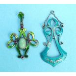 An Art Nouveau green-enamelled white metal pendant of open bow form, collet-set a jade cabochon