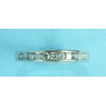 A half-eternity ring channel-set thirteen alternate brilliant and princess-cut diamonds, in 18ct