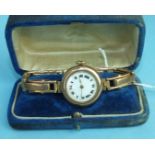 A ladies 9ct-gold-cased wrist watch with gold expanding bracelet, total weight 28.6g, boxed.