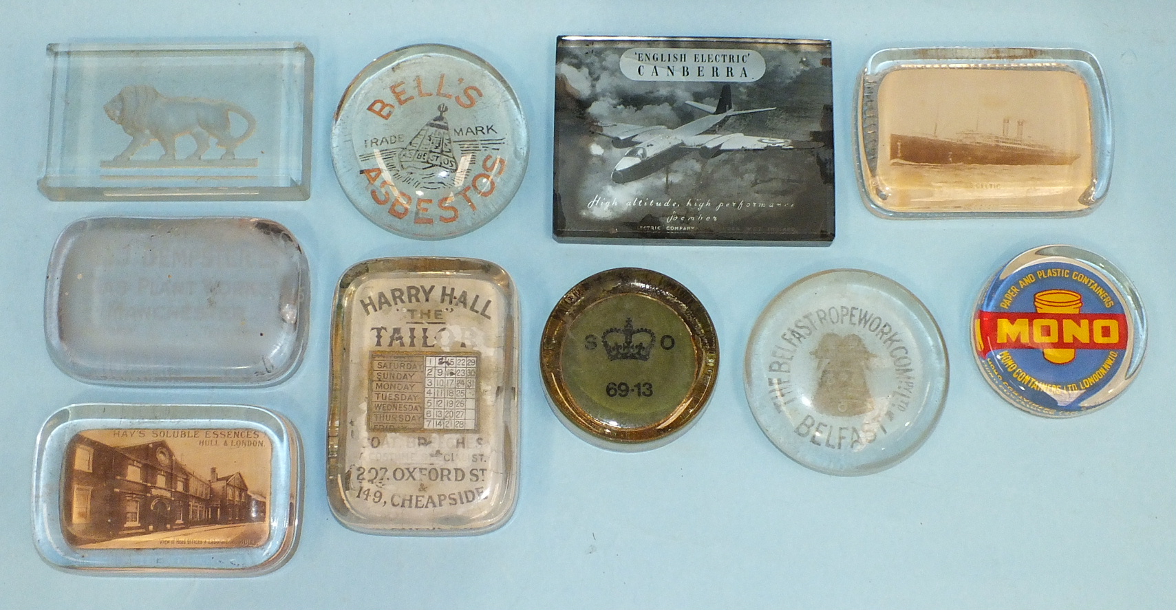 A group of ten advertising glass paperweights, including examples for 'Bell's Asbestos', 'Hay's