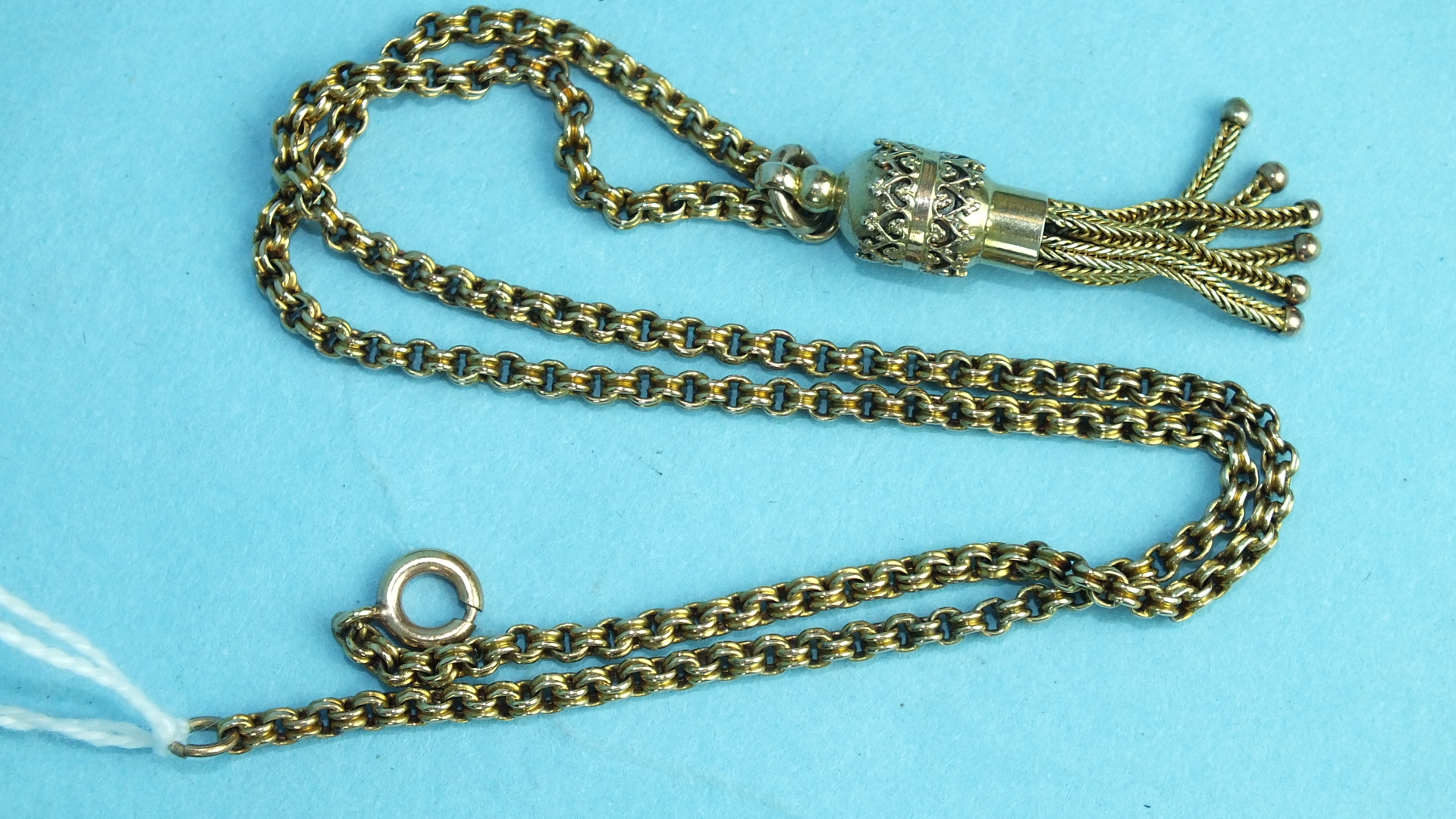 An unmarked yellow metal chain of ribbed belcher links, with plated tassel, 39cm, approximately 7.