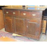 An antique oak dresser base, the rectangular top above two drawers and two cupboard doors, 140cm