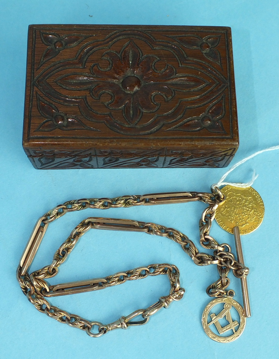 A 9ct rose gold Albert watch chain with Masonic fob and 1785 guinea, (holed), total weight 58g, in
