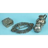 A Chinese white metal pill box with raised dragon decoration, a silver belt buckle with cast mask