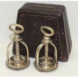 A pair of silver-plated mechanical presses, each with spiral rack acting on a small circular bowl