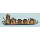 A miniature silver coffee service, comprising: wooden-handled coffee pot, sugar basin with tongs,