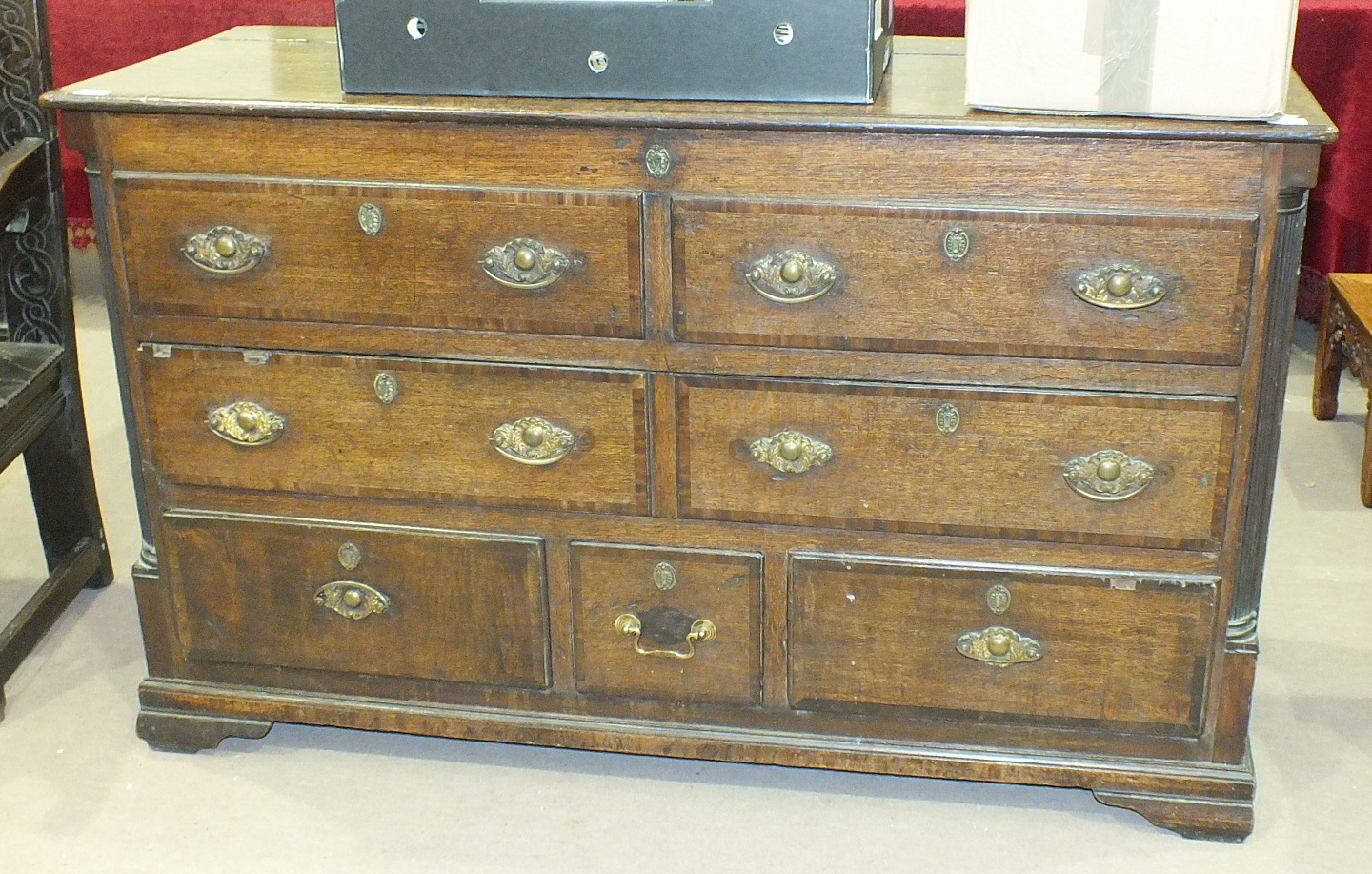 An antique oak mule chest, the hinged lid above two false drawers, one long and three small drawers,