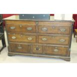 An antique oak mule chest, the hinged lid above two false drawers, one long and three small drawers,