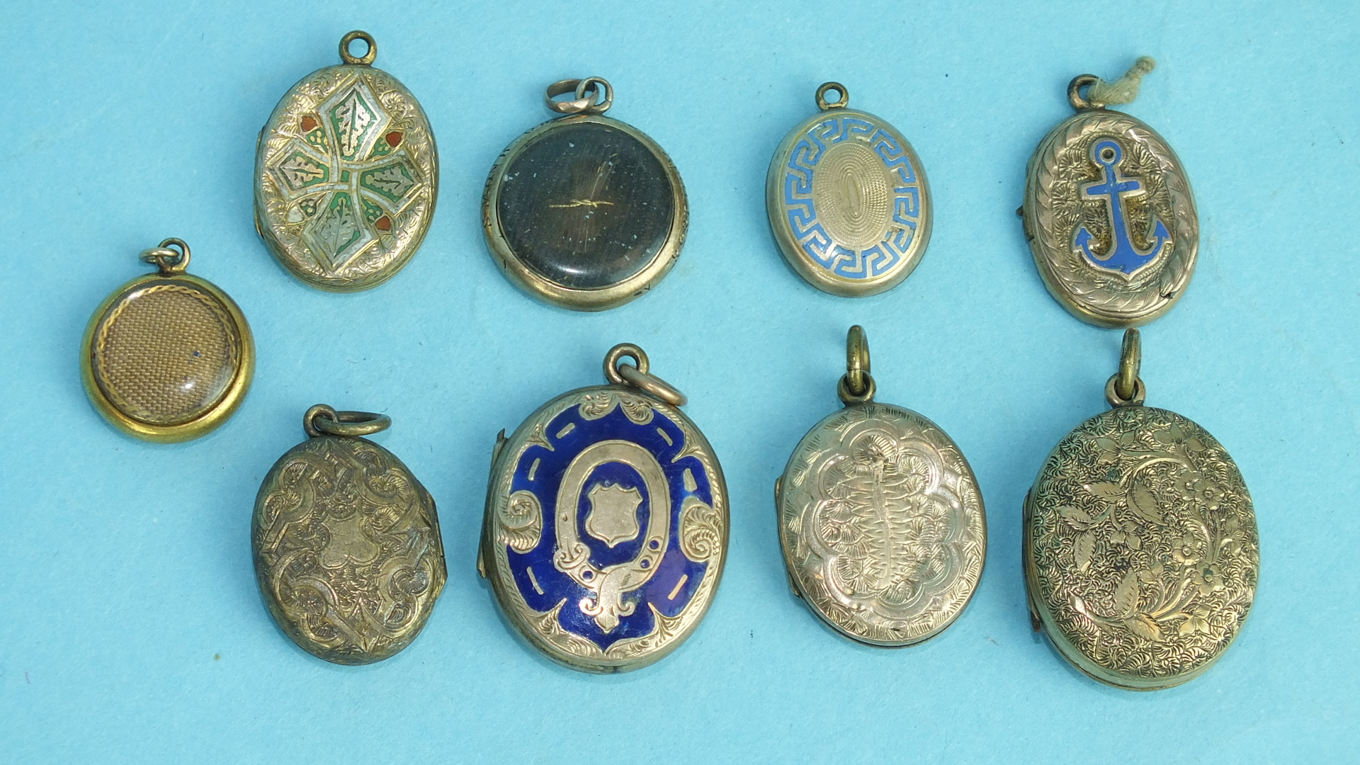 A collection of nine enamelled and engraved lockets, (9).