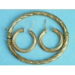 A 9ct gold hinged bangle of twist design and a pair of matching earrings, 8.9g.