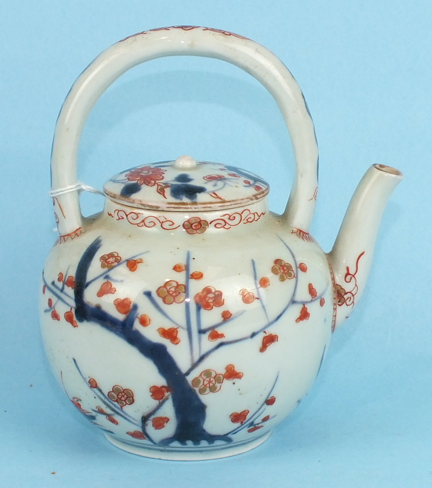 An 18th century Japanese Arita porcelain teapot and cover with loop handle, decorated in Imari