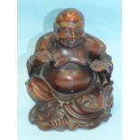 A large 19th century Chinese carved wood figure of a portly Poutai, seated and with a bat on his