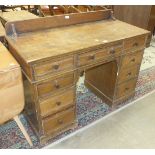 An oak knee-hole desk of nine drawers, 122cm wide, (converted dressing table).