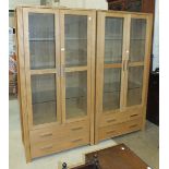 A pair of modern Oaklands Furniture oak display cabinets, each fitted with a pair of glazed doors