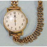 A ladies Tissot wrist watch with raised Arabic numerals, 18ct gold case and 9ct gold brick-link