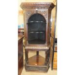 An oak corner cupboard on stand, the arched open cupboard on turned supports and undertier, 100cm