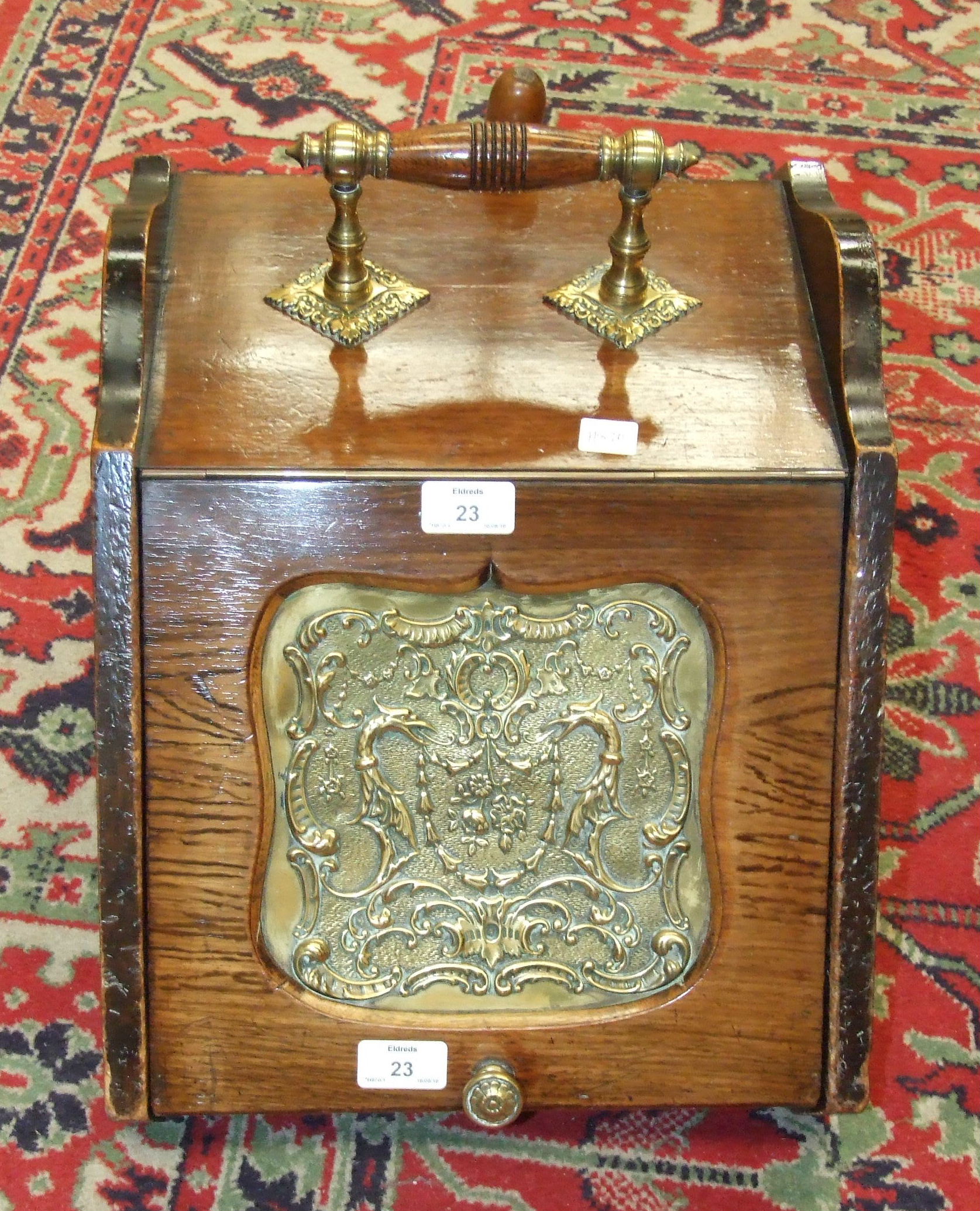 An Edwardian rosewood coal box, the sloping lid with pressed brass panel, complete with liner and