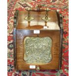 An Edwardian rosewood coal box, the sloping lid with pressed brass panel, complete with liner and