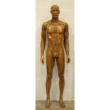 A male shop mannequin of plastic construction, with overall painted wood effect, 188cm.