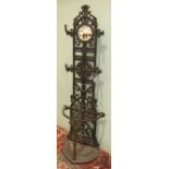 A reproduction cast iron hall stand with four coat pegs, small central mirror and bow-fronted