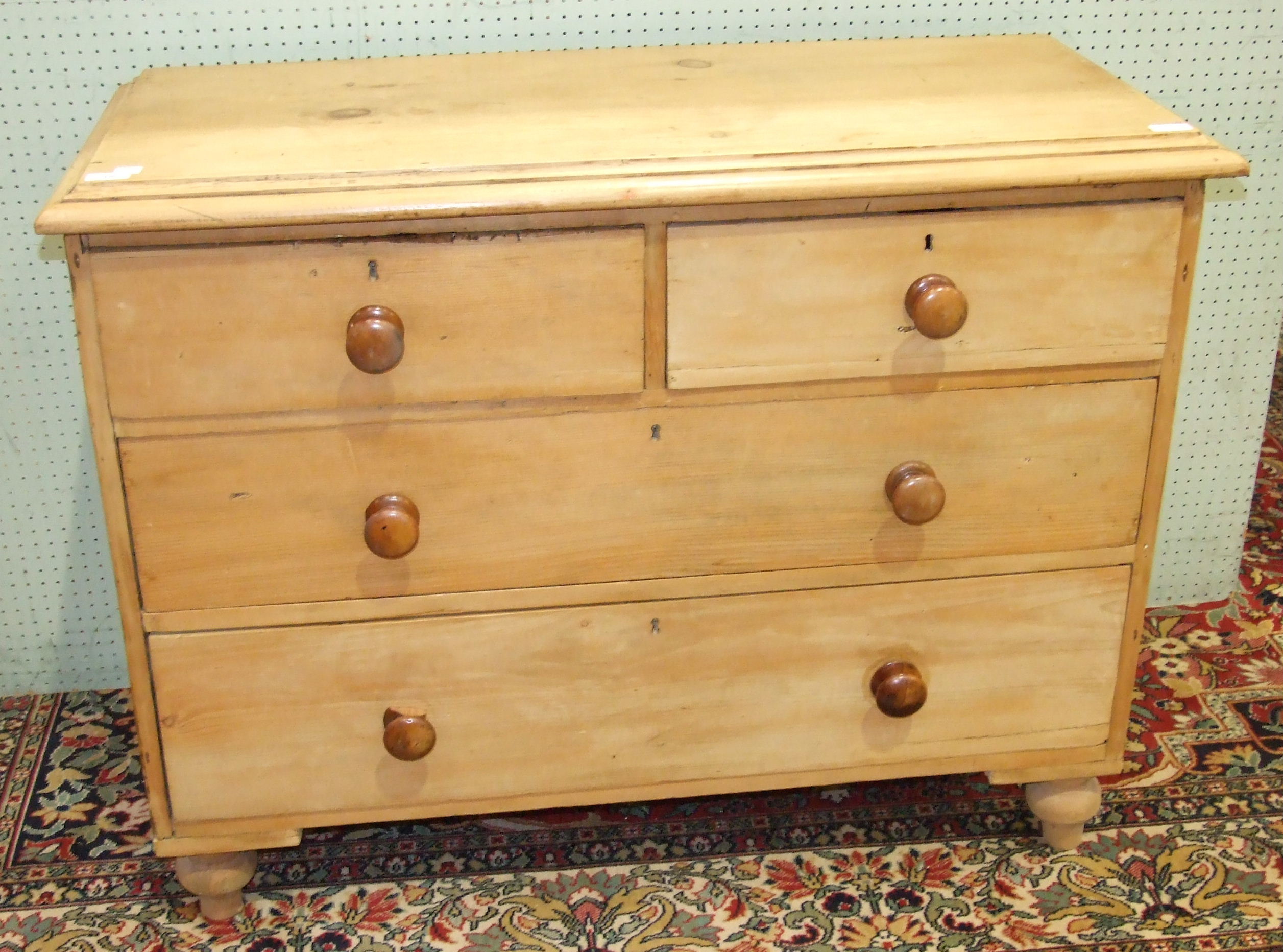 An antique stripped pine chest of two short and two long drawers, on turned feet, 93.5cm wide.