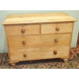 An antique stripped pine chest of two short and two long drawers, on turned feet, 93.5cm wide.