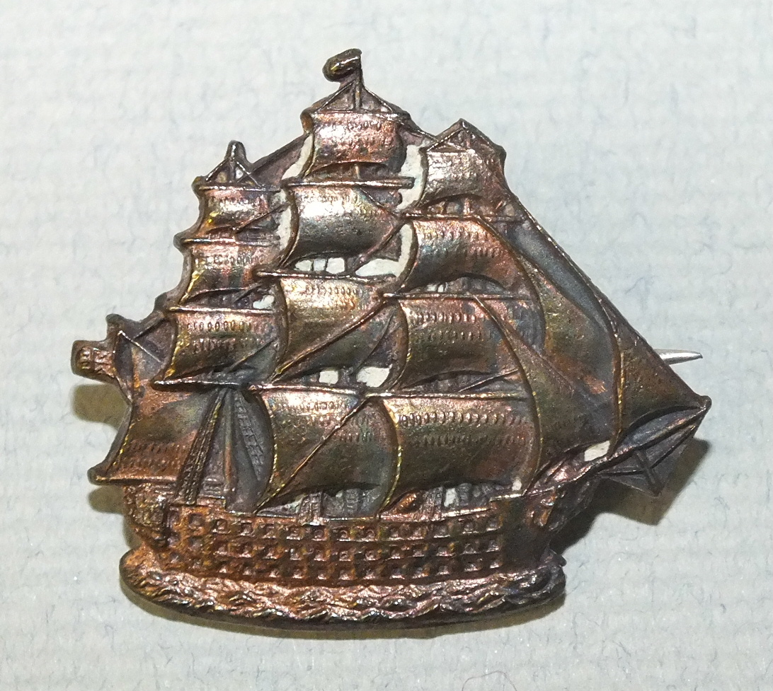 An early-20th century copper badge in the form of HMS Victory, inscribed on the reverse 'Centenary