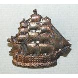 An early-20th century copper badge in the form of HMS Victory, inscribed on the reverse 'Centenary