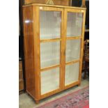 A Continental satinwood display cabinet, the rectangular top above a pair of glazed doors, 102cm