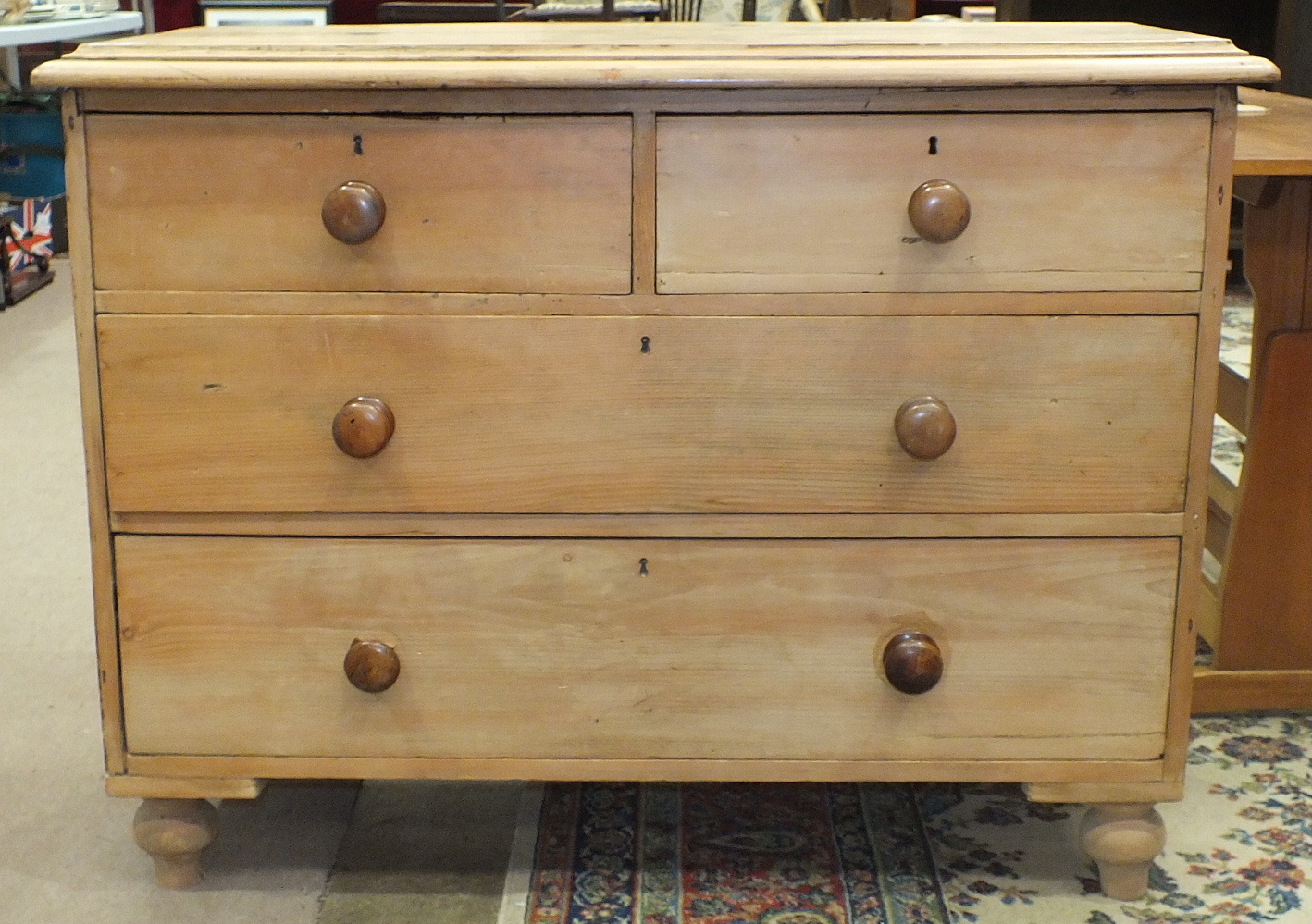 An antique stripped pine chest of two short and two long drawers, on turned feet, 93.5cm wide. - Image 2 of 2