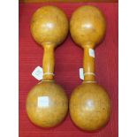 A pair of turned wood dumb bells, 32cm long.