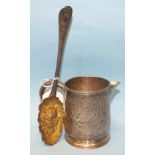 An engraved white metal jug, 9cm high and a white metal berry spoon, (2).