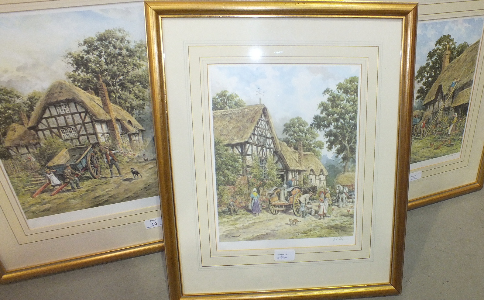 After J L Chapman, 'Figures outside cottage with traction engine approaching', a framed coloured
