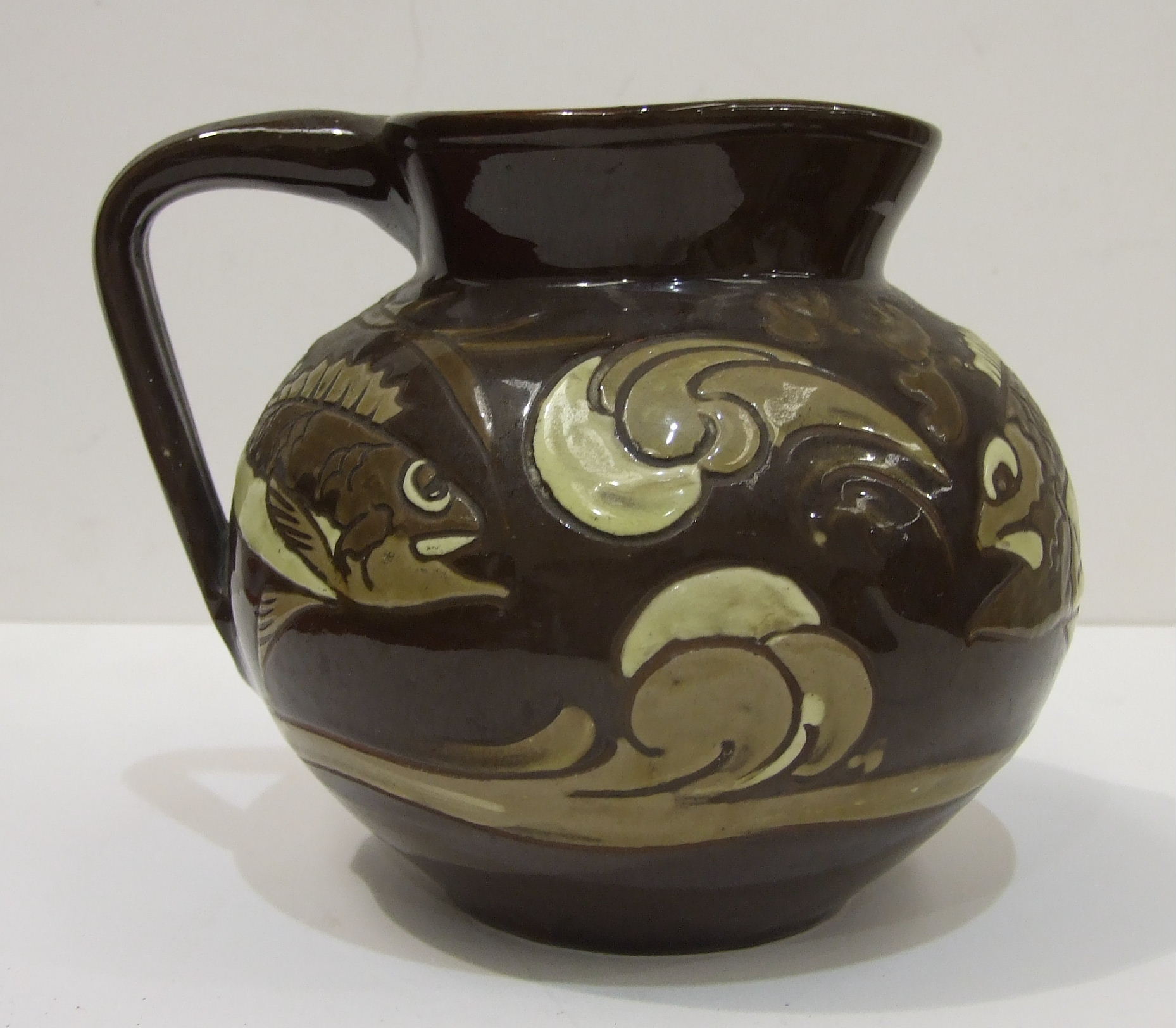 C H Brannam, Barum, a brown-glazed jug of compressed form, with incised marks beneath, dated 1892. - Image 3 of 4