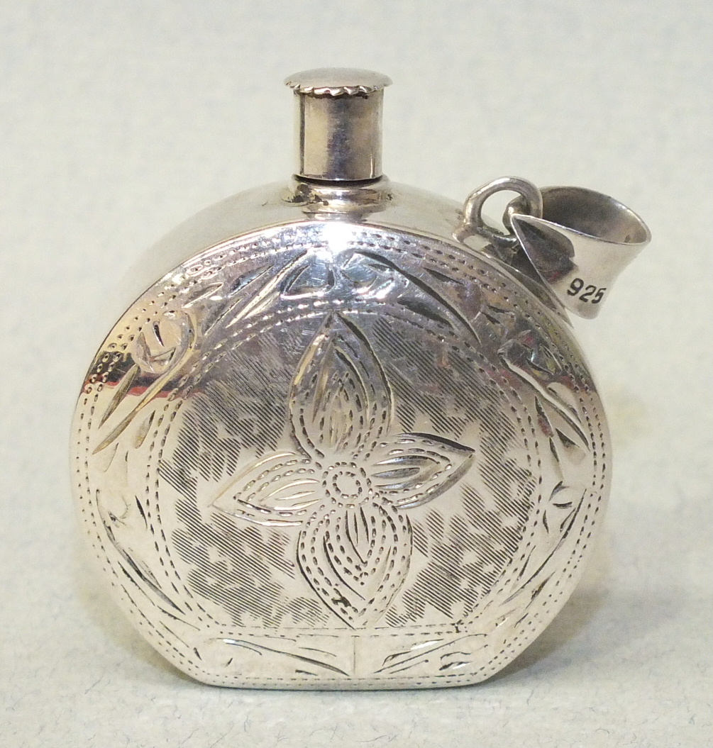 A silver pendant scent bottle of circular form, with engraved decoration, marked '925', 3.5cm