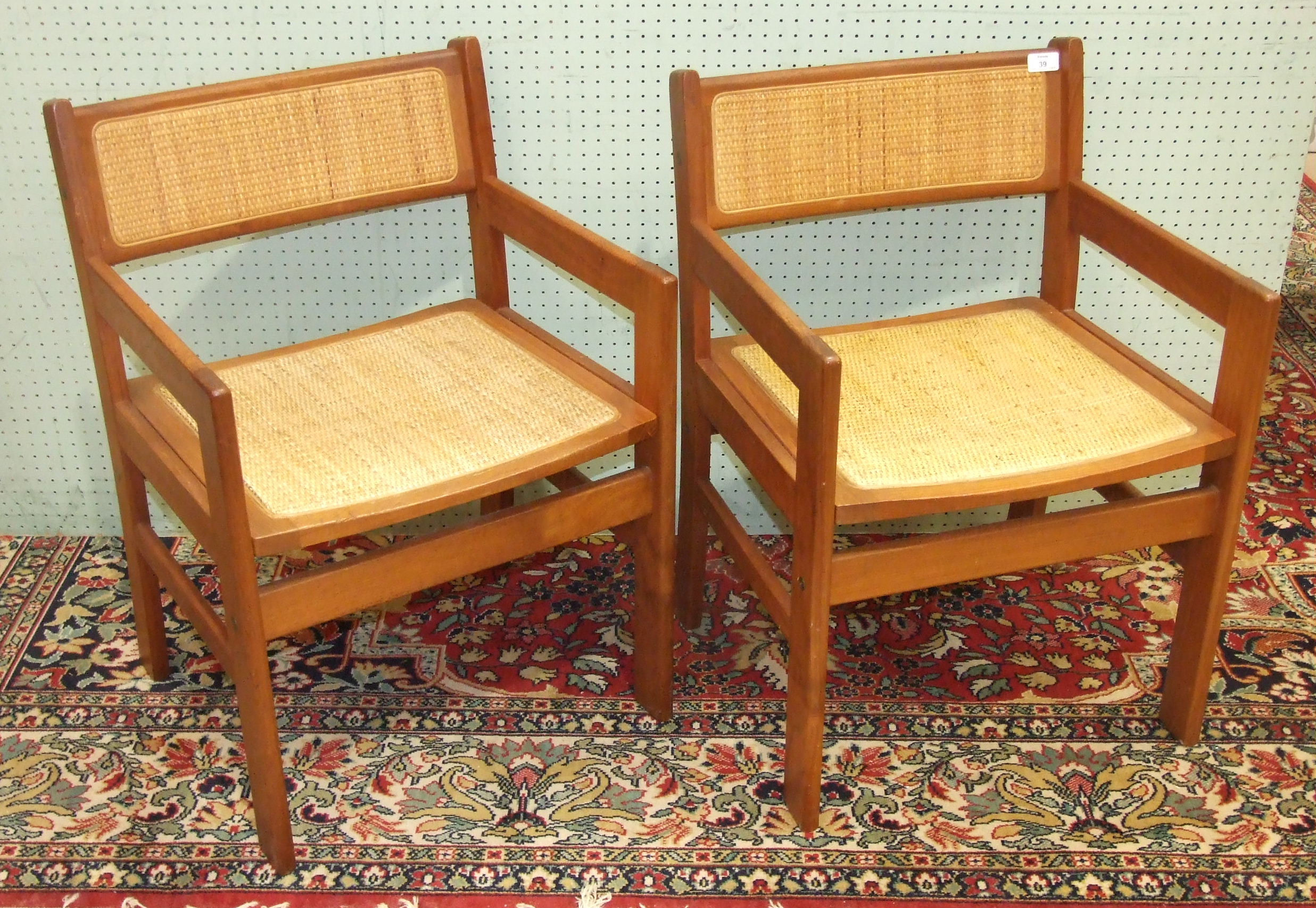 A set of four Scandinavian hardwood dining chairs with raffia backs and seats, two with arms, a