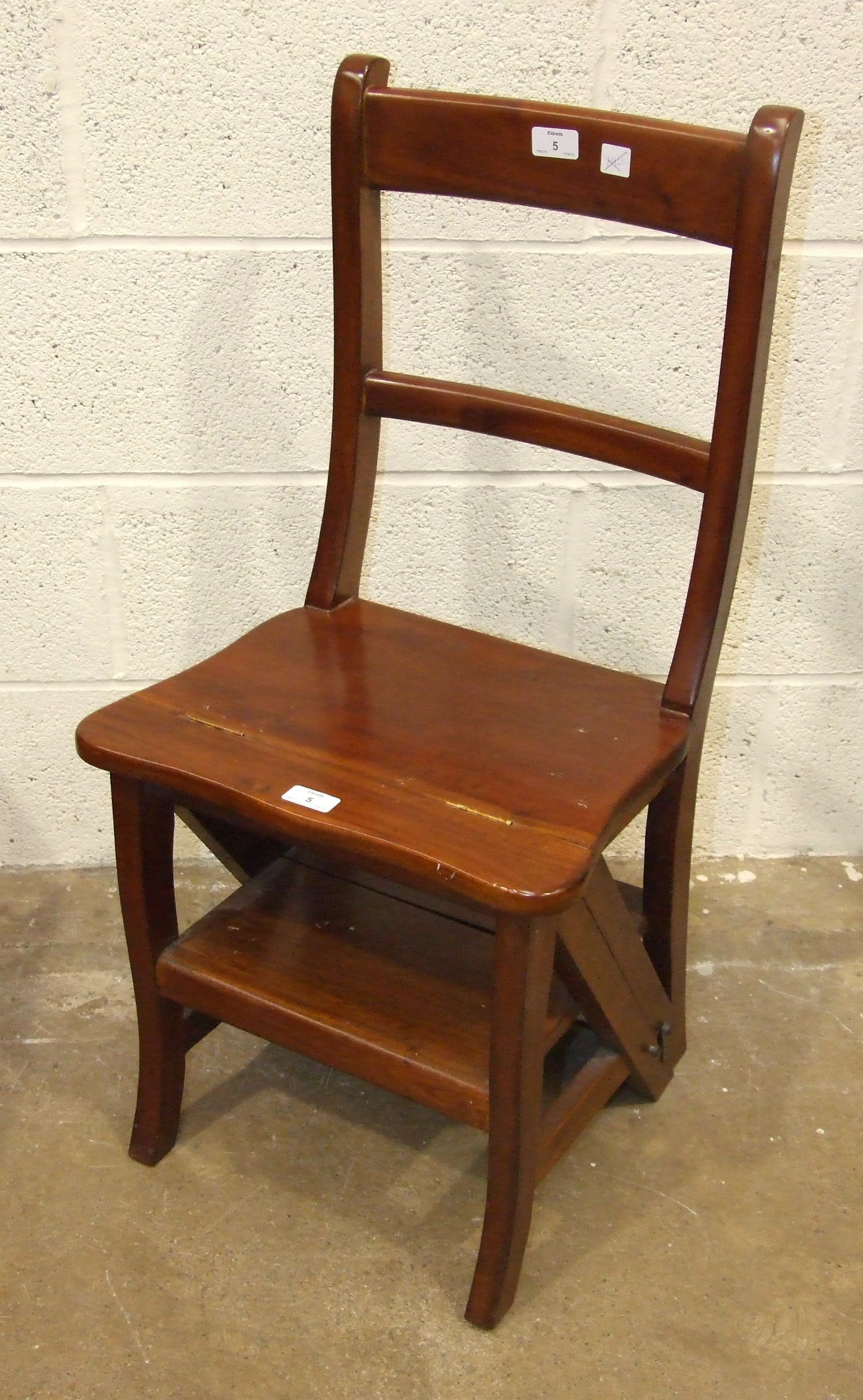 A reproduction hardwood metamorphic library chair.