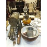 A brass coal helmet, 37cm high, three oil lamps, an oak punch bowl with plated mounts and ceramic