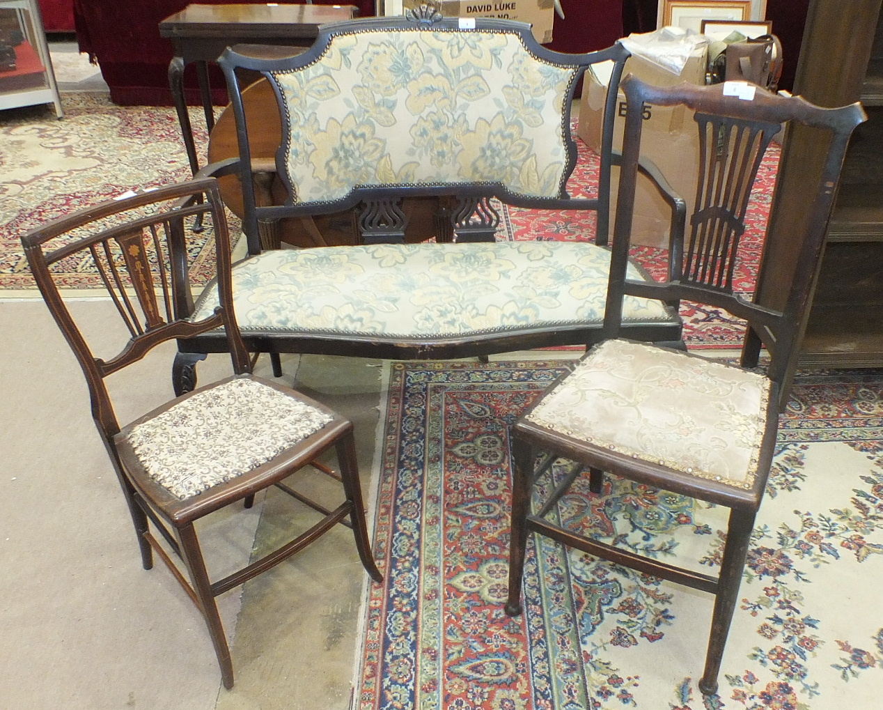 An Edwardian-style two-seater hall seat with padded and pierced back and padded seat, on cabriole