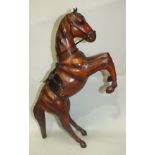 A model of a rearing horse composed of leather stretched over a wooden form, with leather and