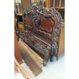 A Continental carved hardwood 5ft bed with pierced headboard, footboard and side rails, together