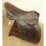 A leather saddle with maker's metal plaque, 'Handcrafted, Shires, Bromyard, England'.