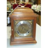 An Elliott mahogany case striking bracket clock with brass handle, the dial marked 'Garrard & Co.