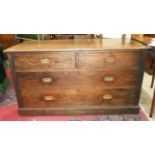 A mahogany chest of two short and two long drawers on plinth base, with recessed military handles,