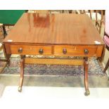 An antique mahogany drop-leaf sofa table fitted with two drawers, on sabre legs, (restored and