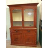 A Victorian stained pine Cornish dresser, the pair of glazed doors above two drawers and two